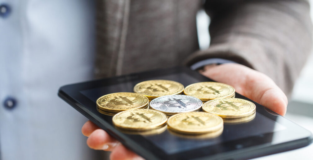 Business man pressing button bitcoin on tablet Business man pressing button bitcoin on tablet.