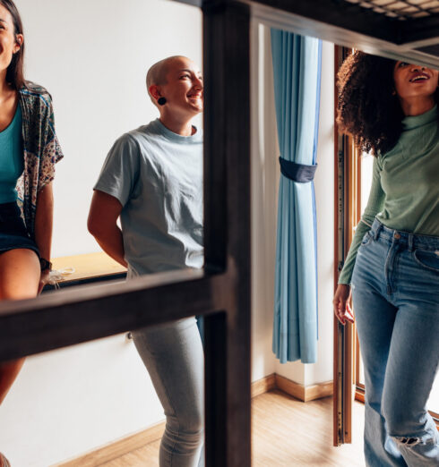 group of female students of different ethnicities talking together in college room - young ladies in youth hostel group of female students of different ethnicities talking together in college room - young ladies in youth hostel