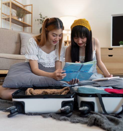 Friendship. Travel together. Two asian young woman friends packing for summer vocation. preparation planning concept Friendship. Travel together. Two asian young woman friends packing for summer vocation. preparation planning concept.