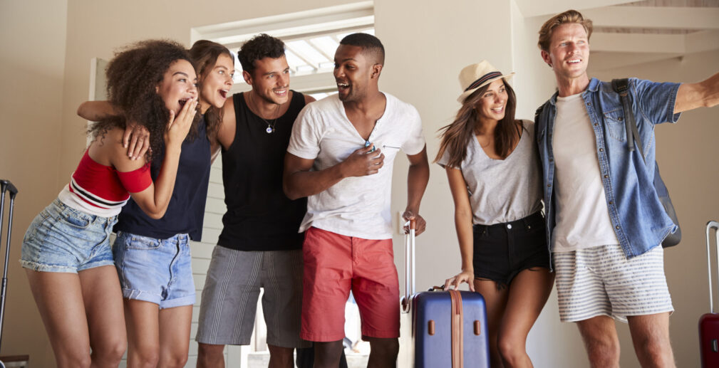 Group Of Friends Arriving At Summer Vacation Rental Group Of Friends Arriving At Summer Vacation Rental
