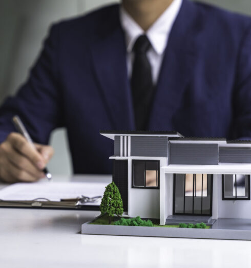 sign-home-sales-contracts-real-estate-agent-emplo-2025-02-19-07-20-46-utc Sign home sales contracts, real estate agent employment contracts, contract documents, home loan insurance, and purchase approval for customers with house designs and keys on the table.