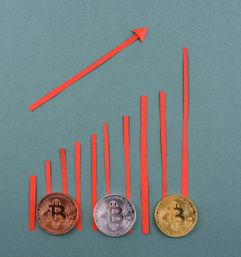 Bitcoin coins. Cryptocurrency growth and fall schedule Bitcoin coins on desk. Cryptocurrency growth and fall schedule