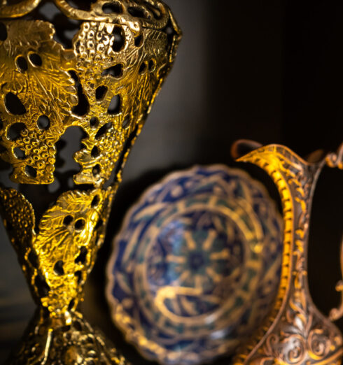 Old copper jug from the east on a black background Old copper jug from the east on a black background.