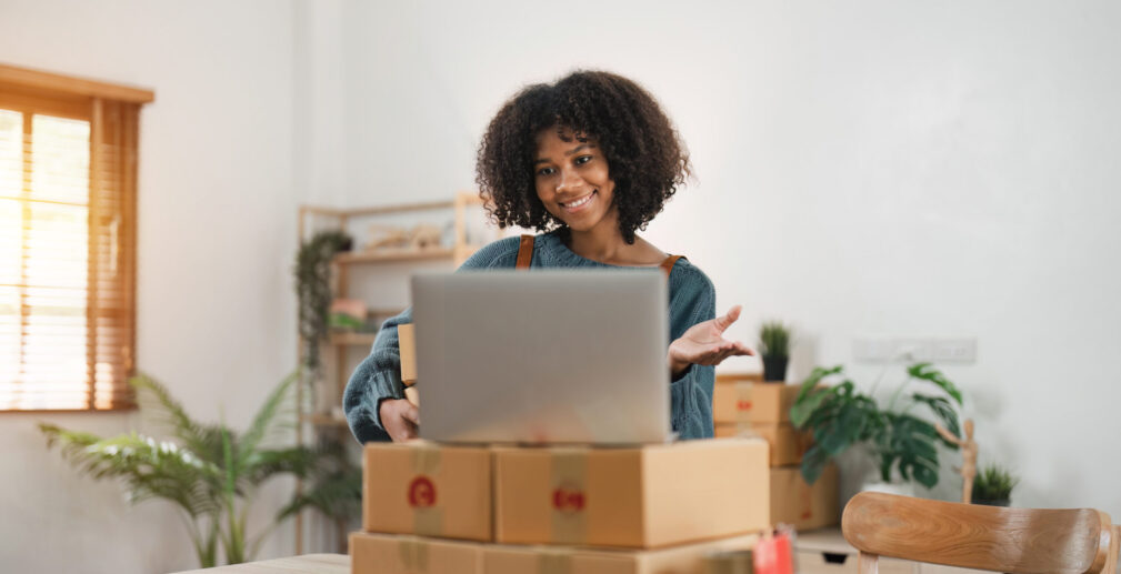 Portrait of Starting small businesses SME owners, African American woman video call check online orders Selling products working with box freelance work at home office Portrait of Starting small businesses SME owners, African American woman video call check online orders Selling products working with box freelance work at home office.
