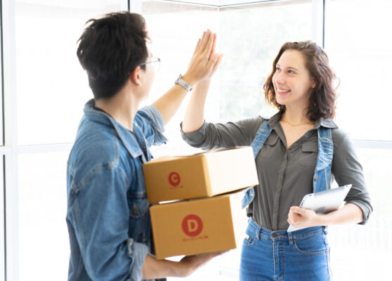 Worker In Warehouse Checking Boxes Using Digital Tablet.Start up small business entrepreneur SME or freelance man and woman working  at home concept, Young Asian small business owner,online marketing.